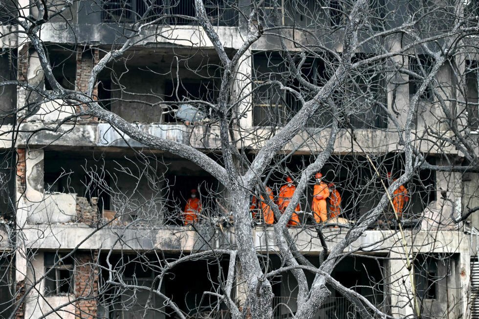 National Disaster Response Force (NDRF) personnel inspect the site after Air India flight 171 crashed in a residential area near the airport in Ahmedabad, on June 13, 2025.