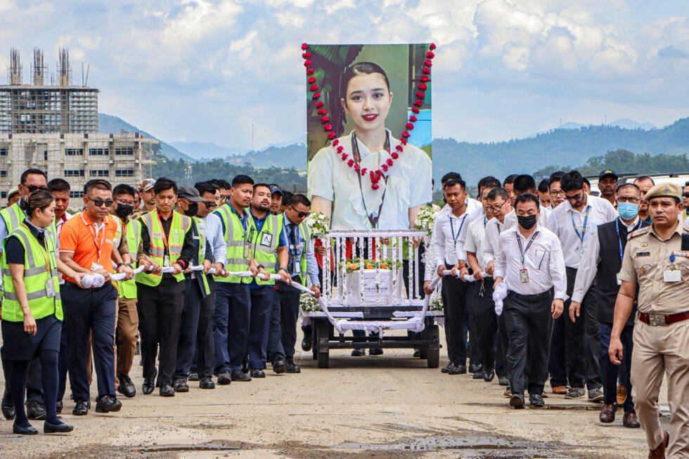 Aviation personnel carry the coffin of plane crash victim Kongbrailatpam Nganthoi Sharma, a cabin crew member of the Air India flight AI171, during her funeral ceremony in Imphal on June 22, 2025.