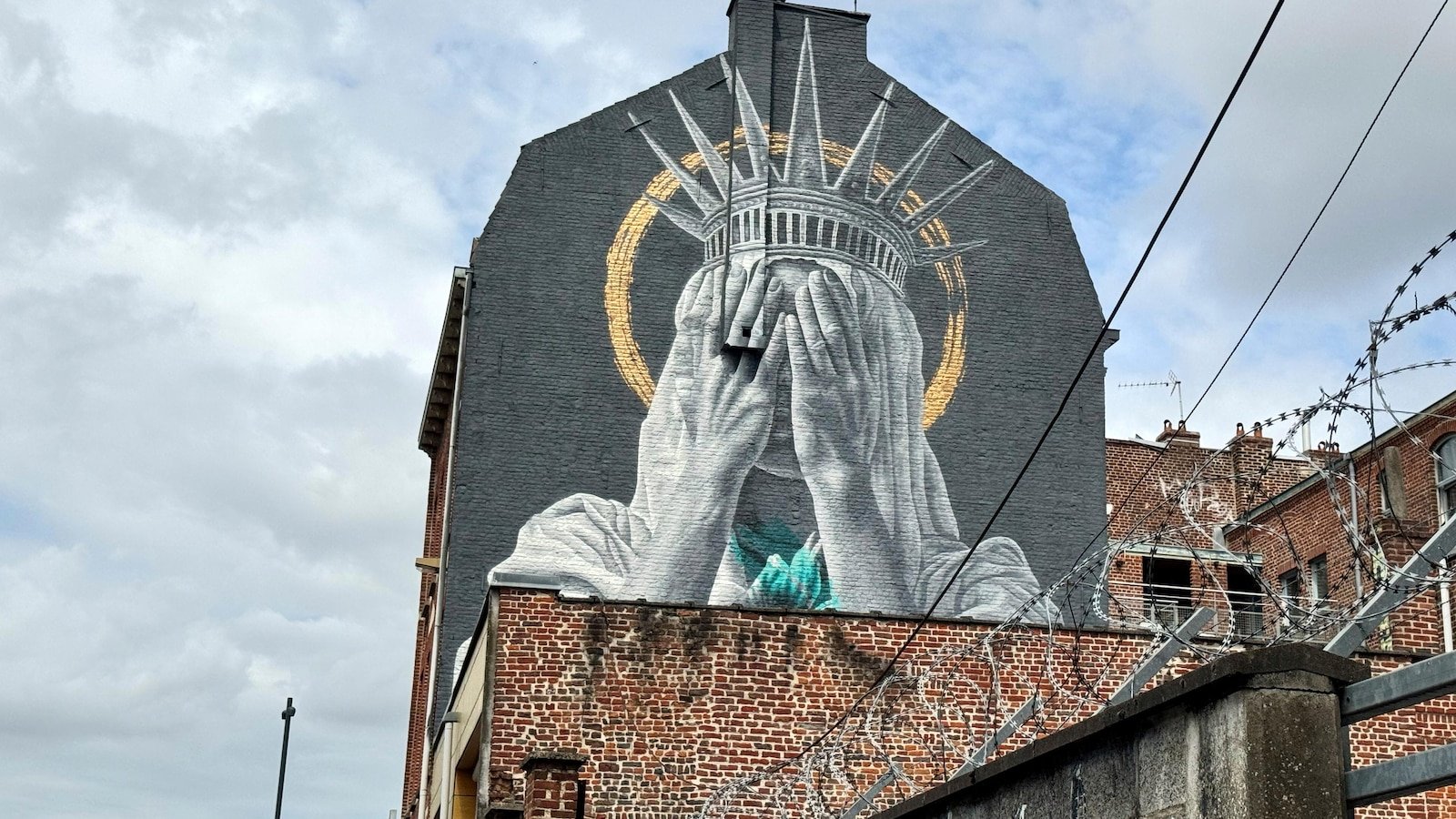A new mural in France shows the Statue of Liberty covering her eyes in a swipe at Trump
